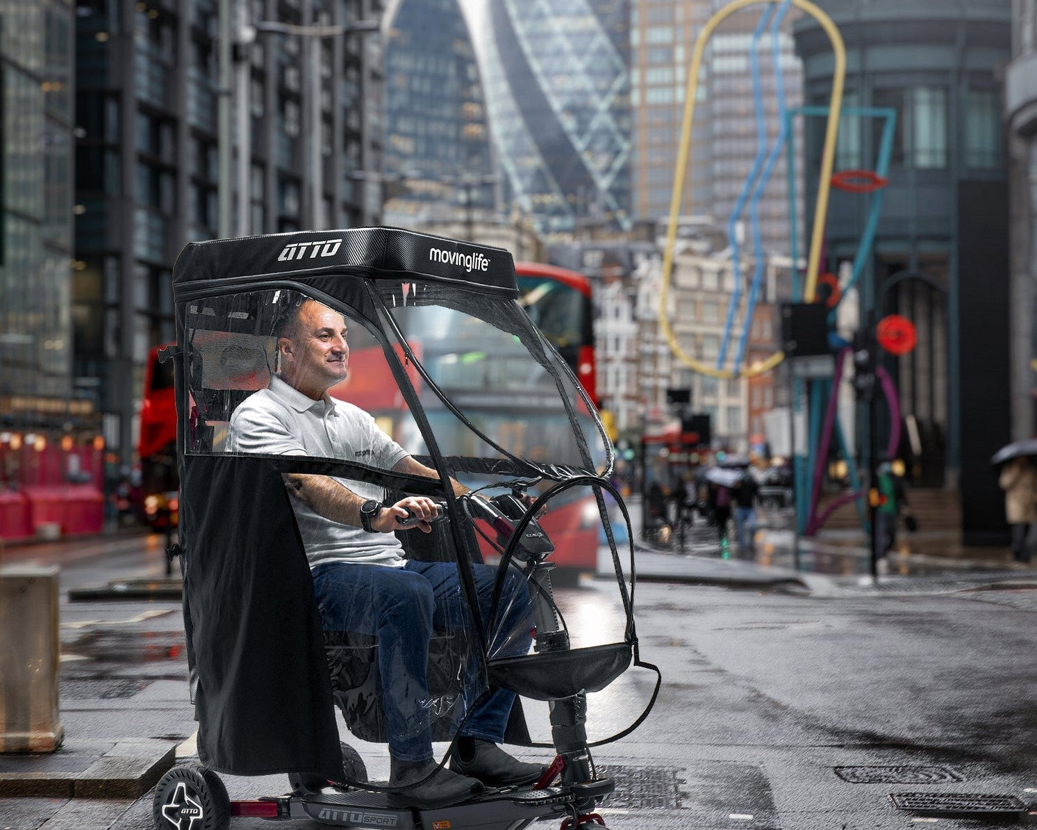 Man in Movinglife ATTO Sport mobility scooter with rain canopy
