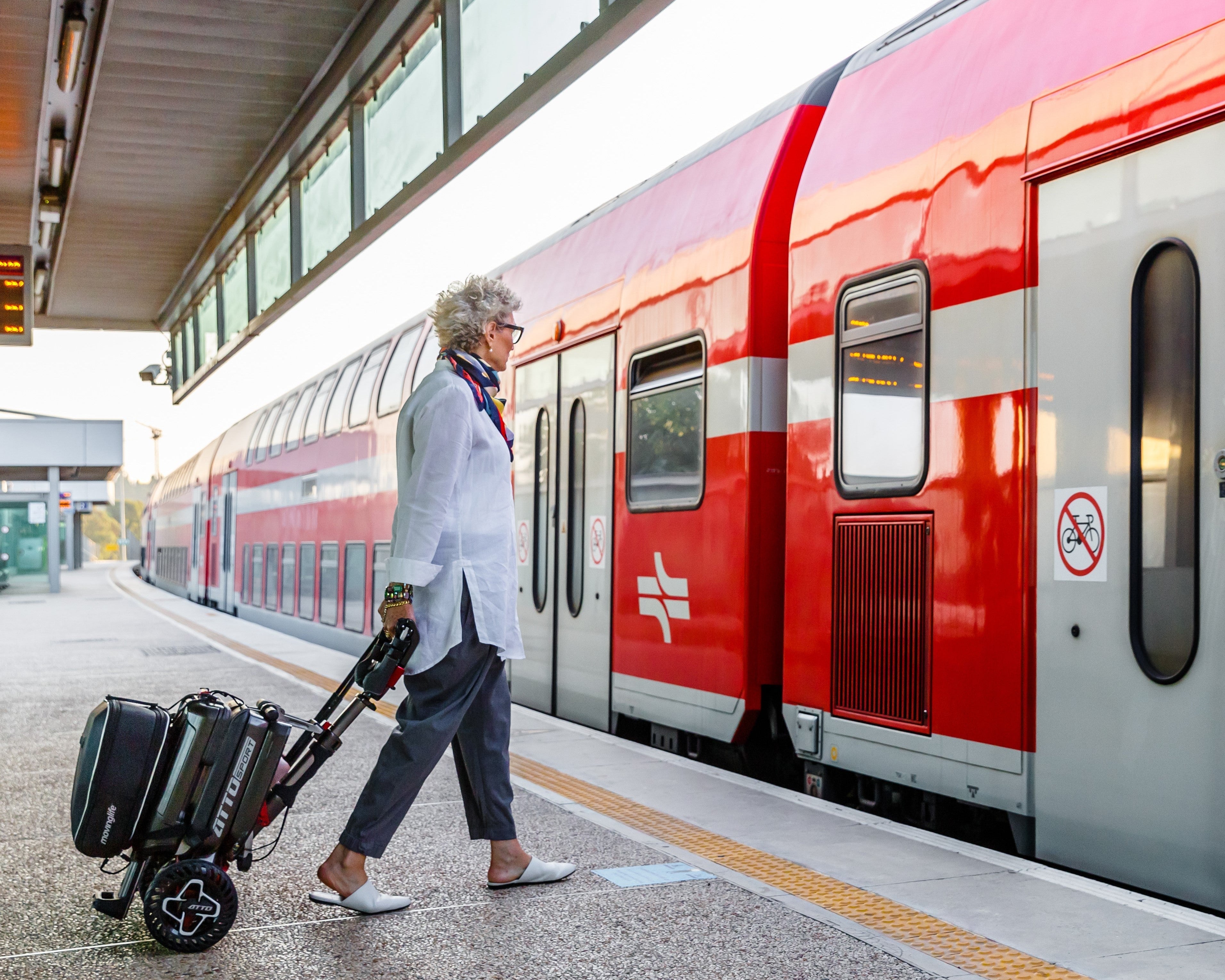 Woman traveling with a foldable mobility scooter