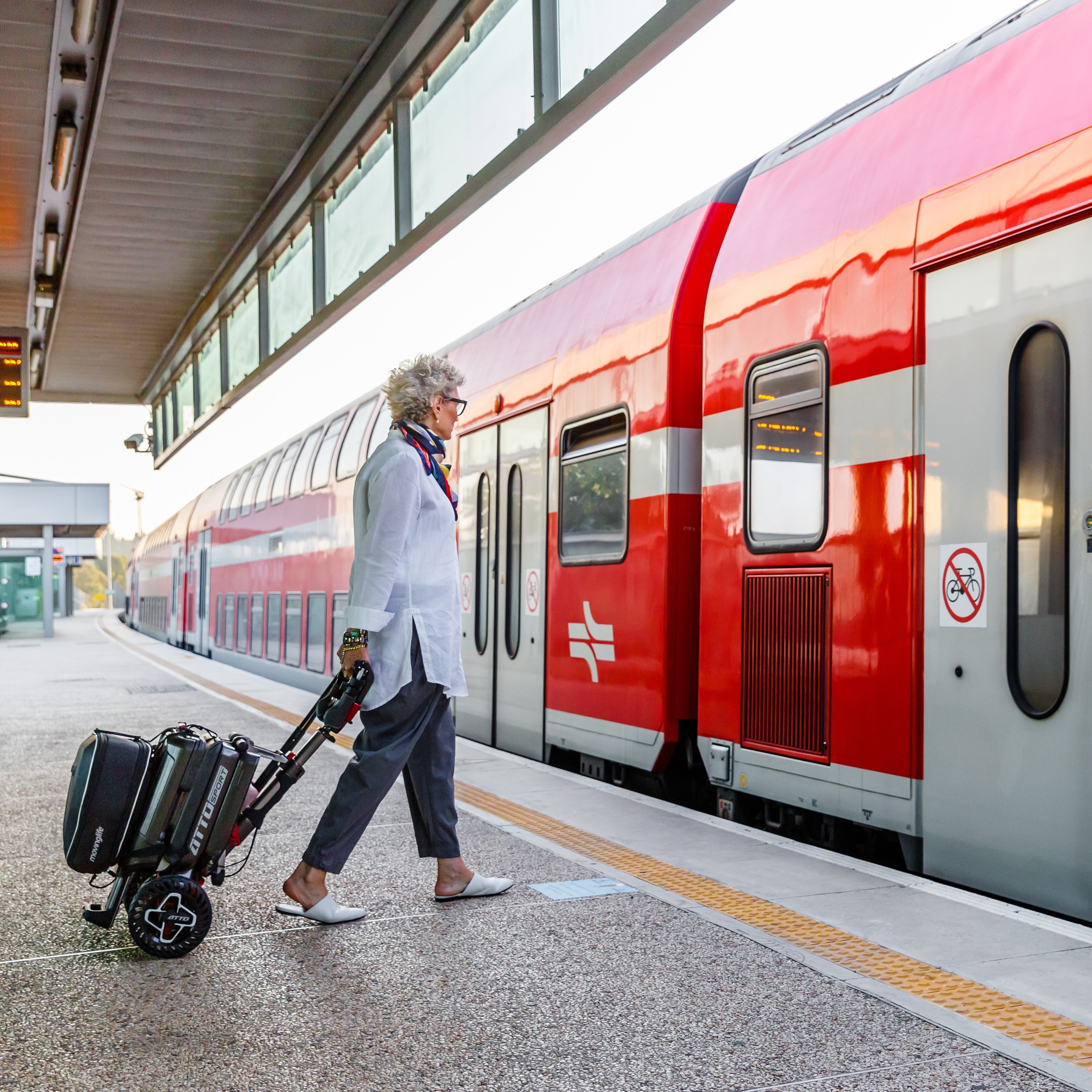 Woman traveling with a foldable mobility scooter